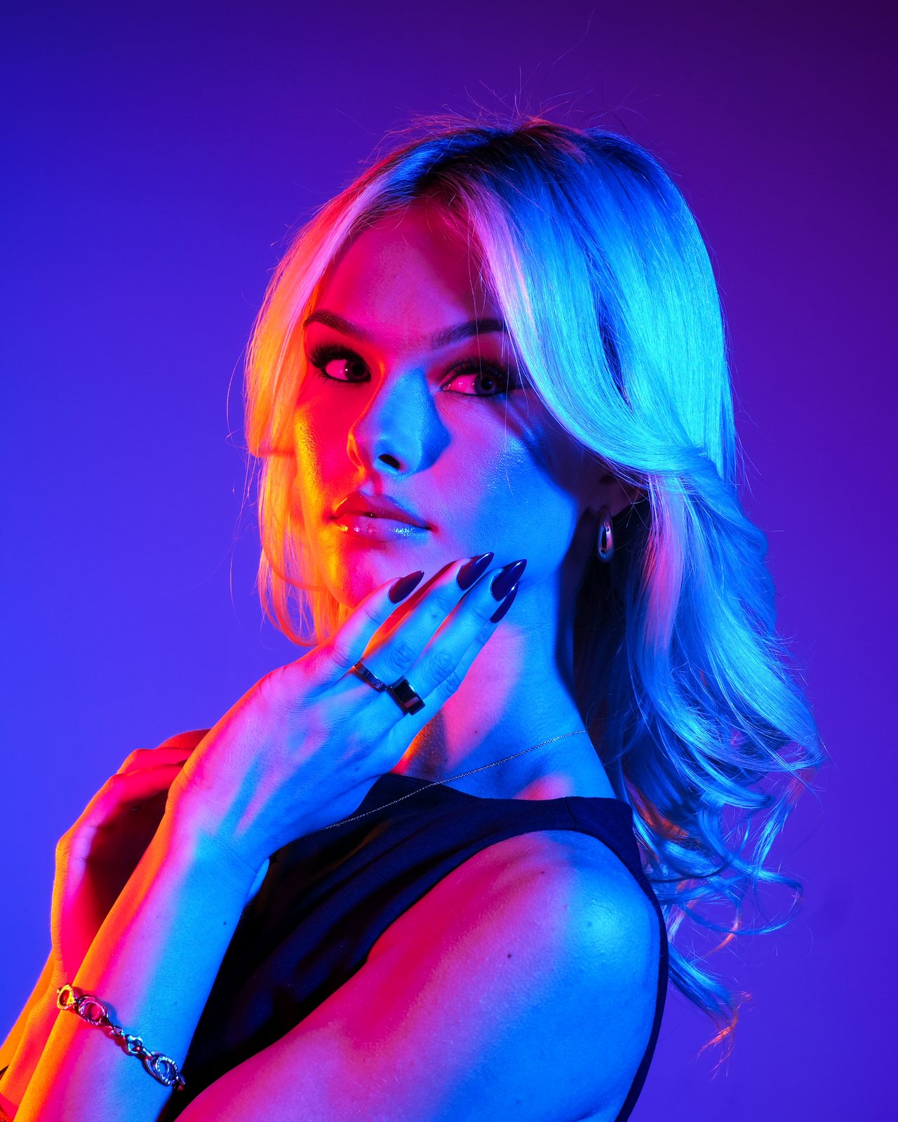 Madeline Grimming in neon pink and blue light